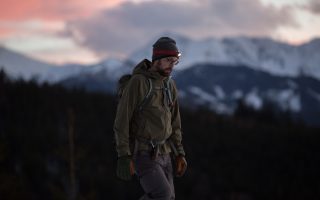 The hiker in winter at sunset